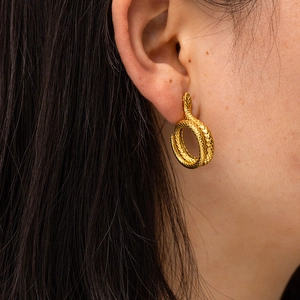 Chic 18K gold plated stainless steel snake hoop earrings worn by a model in a close-up view