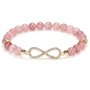 Detail of pink crystal beaded bracelet with a gold infinity symbol and sparkling diamonds