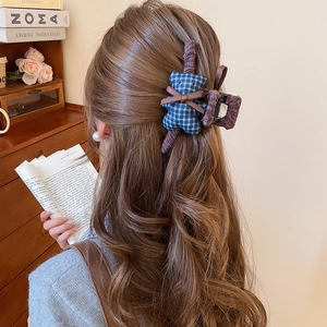 Detailed back view of a blue plaid fabric bear hair claw clip styled on half-up hair