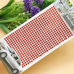 Macro detail of 3mm orange acrylic rhinestone stickers for DIY crafts and decoration