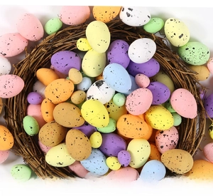 Speckled foam Easter eggs in vibrant colors nestled in a decorative brown twig bird nest