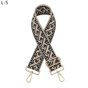 Detail of jacquard ethnic strap with geometric pattern and gold metal lobster clasps