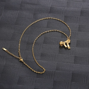 Detail of a gold bow pendant necklace with adjustable chain and lobster clasp