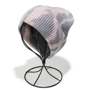 Close-up detail of pink and blue tie-dye knitted beanie with thick ribbed texture