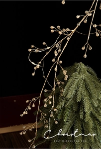 Detail of warm LED light branch with crystal teardrops for Christmas tree decor