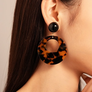Close-up of vintage resin leopard print hollow earrings on a female model