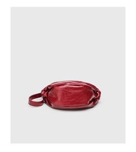 Detailed view of the dark red pleated dumpling bag featuring high-gloss faux leather texture