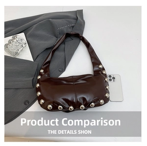 Close-up of dark brown glossy oil wax leather shoulder bag with large silver stud rivets