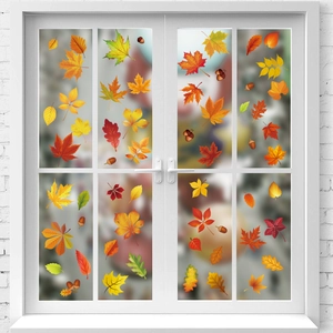 Detail of colorful autumn maple leaves and acorns window decals on a white French door