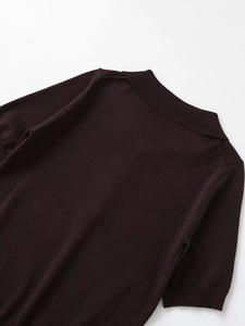 Detail of chocolate brown knit polo collar and shoulder stitching on a casual top