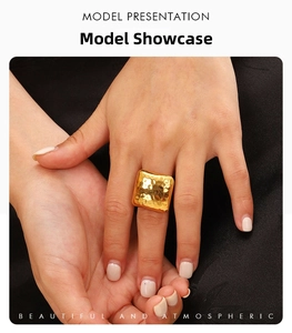 Macro shot of gold hammered texture surface on the statement square geometric ring