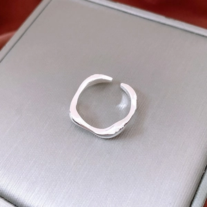 Macro detail of irregular wave 18k gold plated ring with a polished mirror finish surface