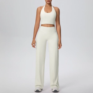Detail of cream white halter neck sports top and wide-leg yoga pants set for women