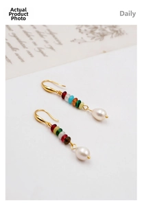 Detail of bohemian gold drop earrings with multi-color beads and freshwater pearls