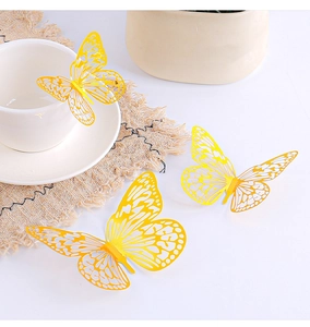Three bright yellow 3D laser-cut butterflies perched on a white coffee cup and table
