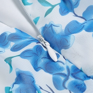 Detailed close-up of a high-quality invisible zipper on a blue floral print dress