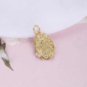 Close-up of golden oval pendant with love you wildly engraving and floral border