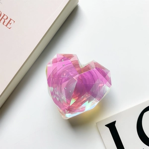 Top view of a pink holographic heart-shaped phone grip on a minimalist desk setup