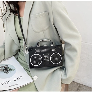 Retro radio-shaped crossbody bag shown on a model in a stylish mint green blazer