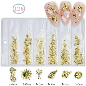 6-grid gold metal nail art charms set with sea motifs and size details in a clear case