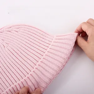 Close-up of pink ribbed knit baby hat showing soft texture and high elasticity detail