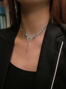 Detail of elegant butterfly rhinestone necklace and matching long tassel earrings set