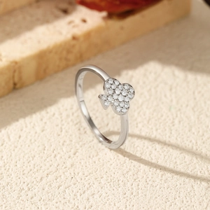 S925 sterling silver clover ring with sparkling moissanite stones on a textured stone base