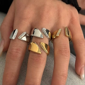 Modern asymmetric stainless steel open ring with diamond inlay shown on model's hand