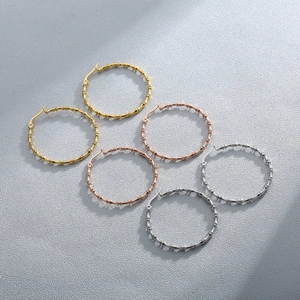 Detailed close-up of bamboo texture hoop earrings in gold, silver, and rose gold finishes