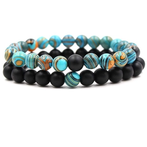Detail of 8mm volcanic stone and marble beads on elastic bracelets in a 2-piece set