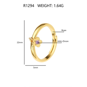 Detail view of gold brass open ring with purple zircon flower pendant and product specs