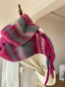 Detail of soft brushed plaid shawl scarf in vibrant pink and green gradient tones