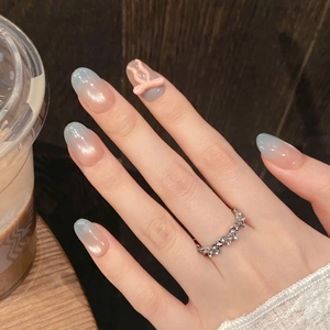 Detailed view of 3D pink bow decoration on blue and pink gradient press-on nails