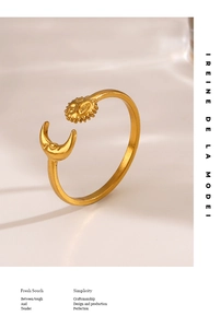 Macro detail of sun and moon open ring in gold finish with celestial design