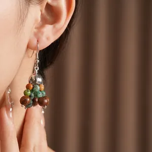 Bohemian dangle earrings with green stone beads and vintage brown wood accents