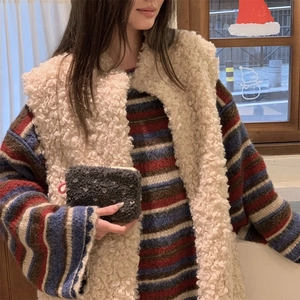 Detail of dark gray fleece coin purse with zipper and pink loop held by model
