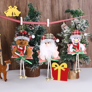 Three Christmas plush ornaments including Santa, reindeer, and snowman with golden bells