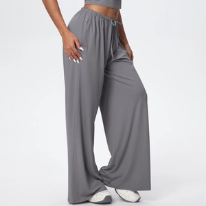 Detail shot of grey wide-leg lounge pants showing the soft draped fabric and drawstring waist