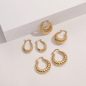 Three pairs of 14K gold plated hoop earrings with twisted, threaded and beaded textures