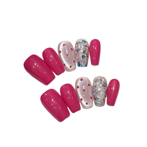 Pink cat eye press-on nails with retro polka dots and sparkling silver glitter accents