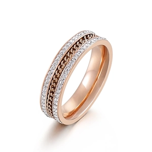 Rose gold triple-layered ring with sparkling crystals and a central Cuban link design