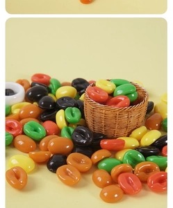 Close-up of colorful resin coffee bean models in a miniature basket for DIY crafts