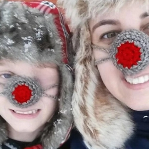 Detail showing hand-crocheted gray and red wool nose warmer for winter warmth