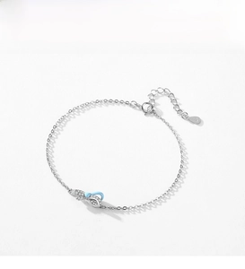 Detailed shot of S925 silver bow bracelet with blue enamel and sparkling pavé stones