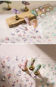 Macro shot of 3D floral nail art stickers with elegant ribbon and petal textures