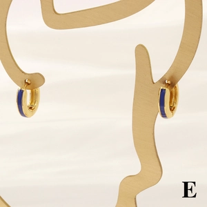 Detail of 18K gold-plated hinged hoop earrings with dark blue enamel on art stand