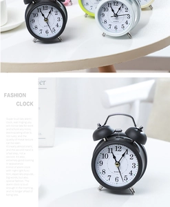Detail view of colorful retro twin bell metal alarm clocks with quartz movement dials