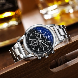 Macro detail of Geneva quartz chronograph watch with black dial on a wooden tray