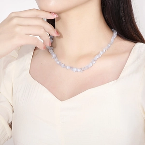 Irregular light purple cat eye stone bead necklace shown on a model neck