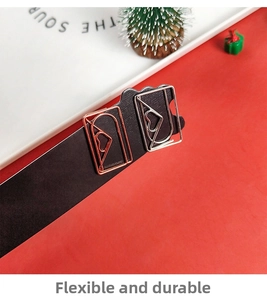 Close-up of heart-shaped metal paper clips in rose gold and silver on red backdrop